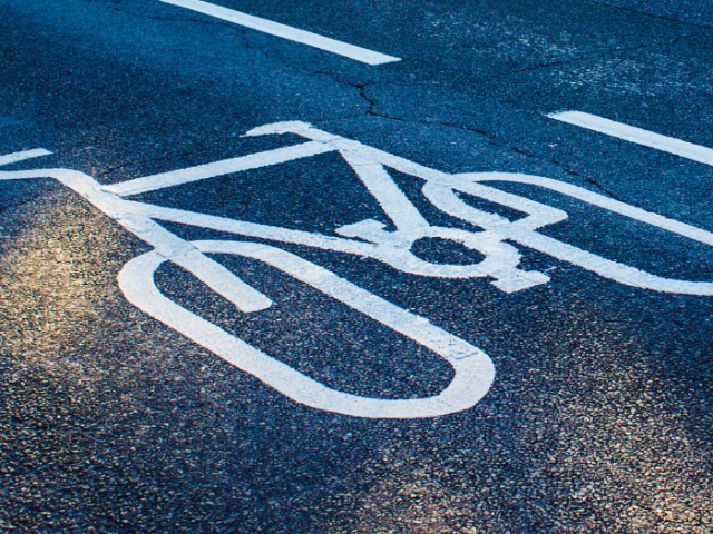 A picture of a bicycle painted on a tarmac road