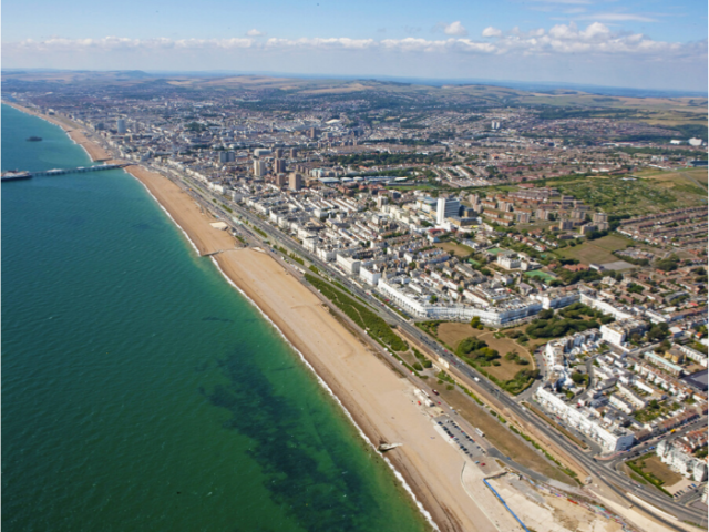 An ariel view of a city with sea, beach and buildings