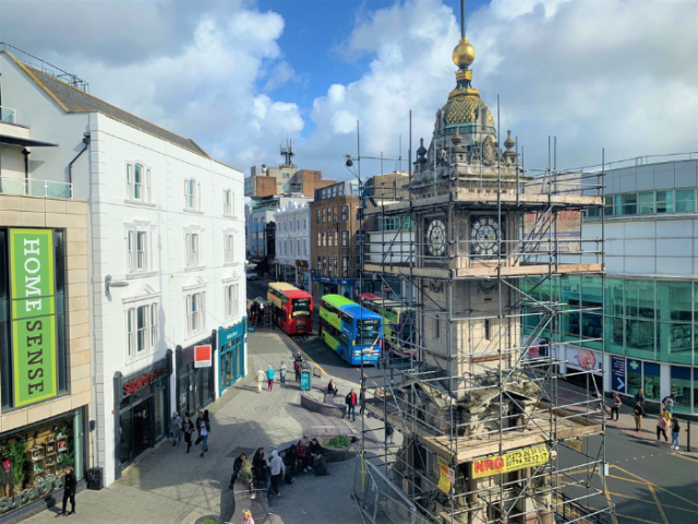 A picture of a clock tower surrounded by scaffolding
