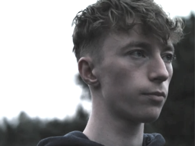 Image of teenage boy looking away from the camera 