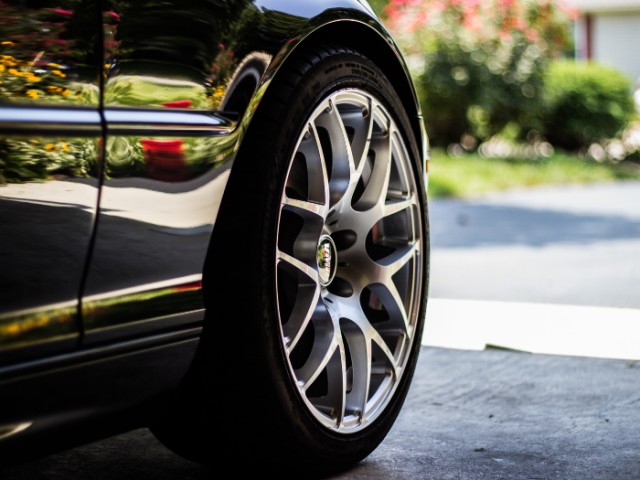 A picture of a car wheel on a road