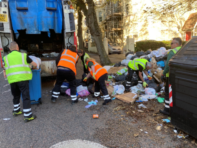 Image of Cityclean staff clearing rubbish around communal bins