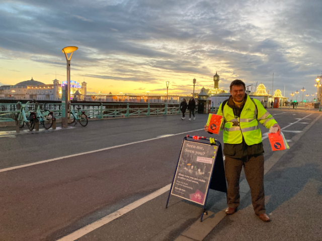 A man in a high vis jacket alongside a cycle lane