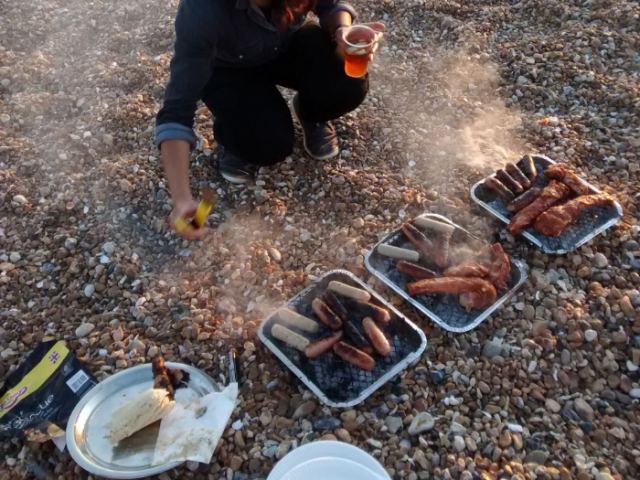 Image of someone using cheap, single use disposable barbeques