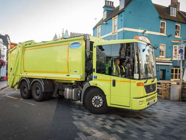 Picture of a Cityclean truck driving through Brighton city centre.