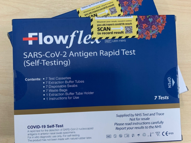 Two blue boxes of lateral flow test kits