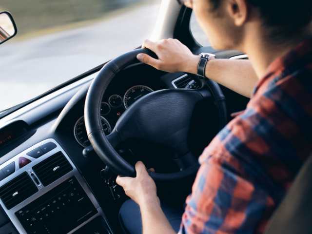 A picture of a person driving a car