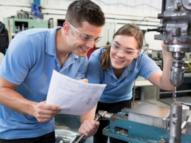 A male and a female apprentice at work