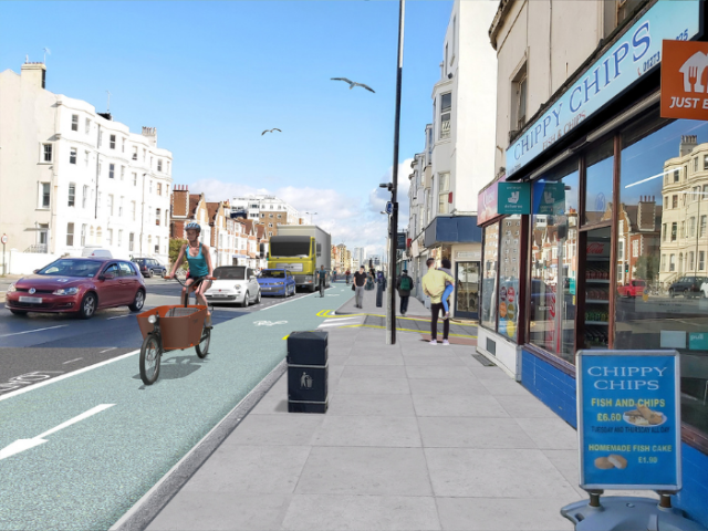 An artists impression of a road with a cycle lane, pavement and shops