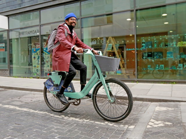 A man riding a bike on a road
