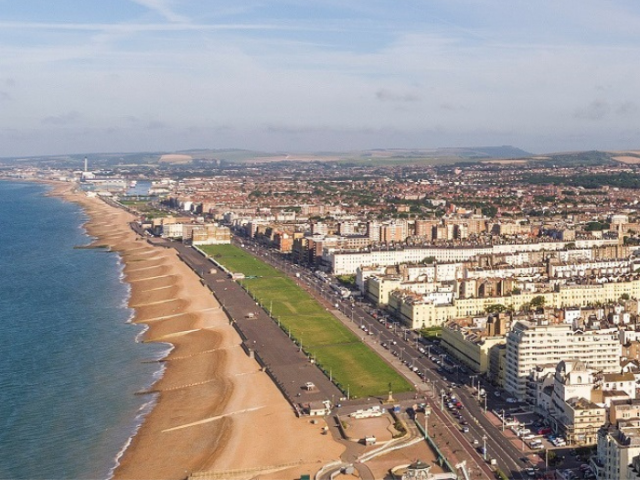 High level aerial view of the beach and seafront properties from the i360 stretching west beyond Shoreham.