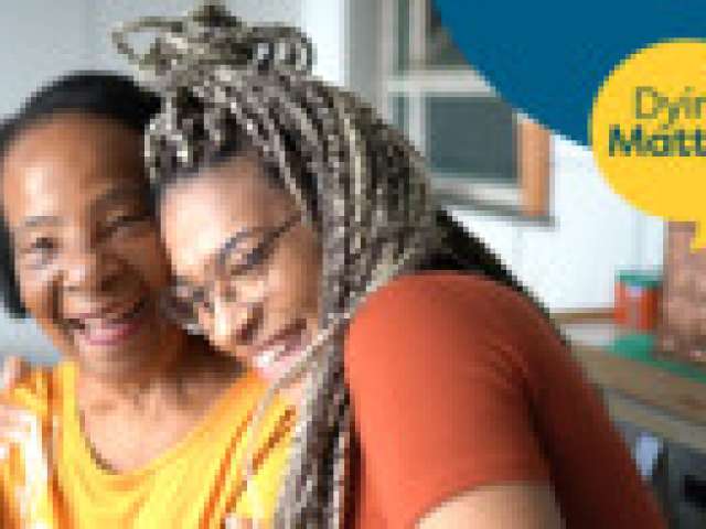 Two women, an older woman and a younger woman  with arms round each other in discussion. A logo with a yellow speech bubble saying Dying Matters
