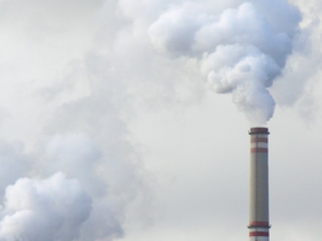 A picture of a chimney with white smoke coming out of it