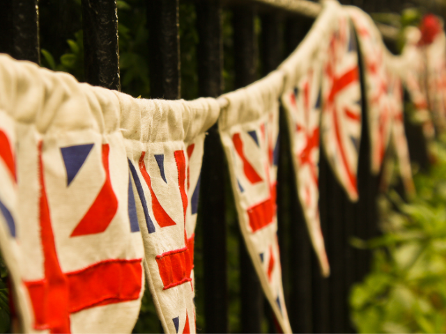 Union Jack bunting hanging on a fence
