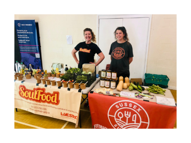 Two women stand behind neighbouring stalls at the Communities, Food and the Circular Economy Event. In front of them is an array of produce.