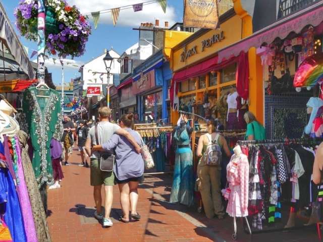 Shopper stroll  on a busy and colourful street. Bunting overhead.