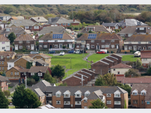 General view of houses and flats, some with solar panels on the roof
