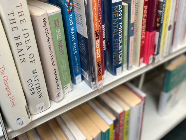 Library shelf full of books on mental health