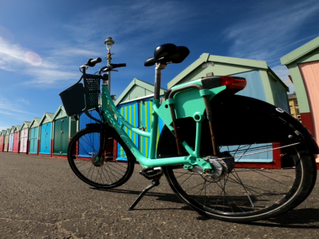 A bike in front of beach huts