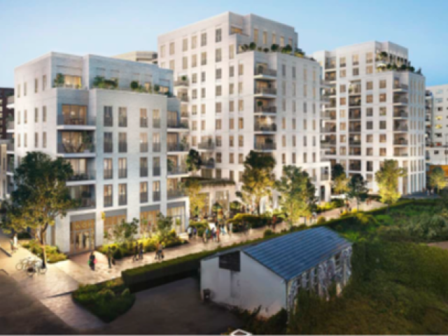 An artist's impression of the proposed new gasworks development shows four multi-story white buildings in a row, the middle two being taller than the outer ones. The buildings are set next to a road on the right where traffic with lights on can be seen. The walkway surrounding the development is also lit up in a dusk scene. 