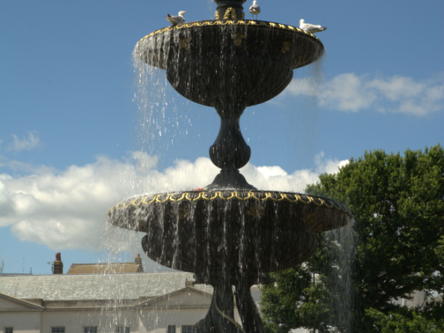 The Victoria Fountain, Old Steine Gardens, Brighton with seagulls bathing in the top bowl