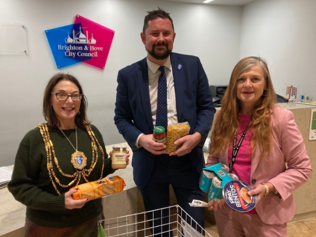 The Mayor of Brighton & Hove Councillor Lizzie Deane, council leader Councillor Phelim Mac Cafferty, and leader of the opposition Councillor Carmen Appich donating food at the food collection point in Hove Town Hall.