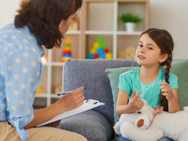 The image shows a social worker talking to a young girl.