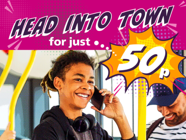 A young person on a bus holding his phone to his ear