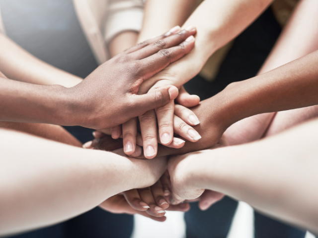 Photo of people clasping hands