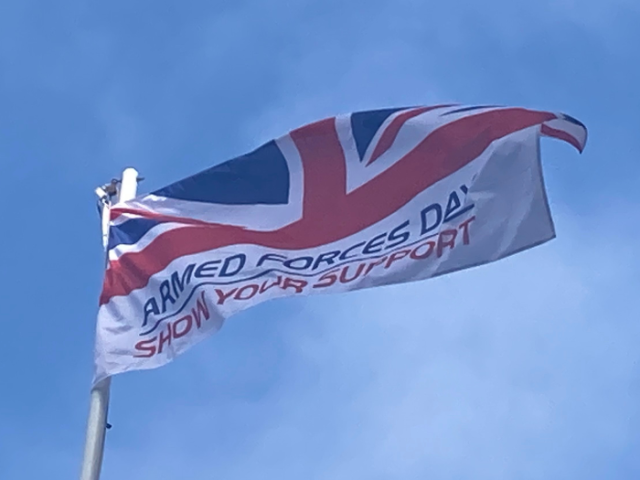 Photograph of the Armed Forces Day flag flying against a blue sky at Hove Town Hall