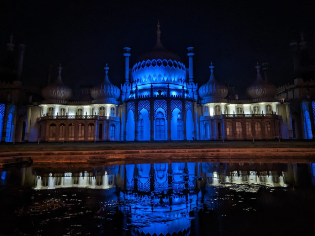 Photo of the Royal Pavilion at night, lit up in blue and white lights