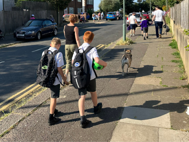 children and parents walking to school