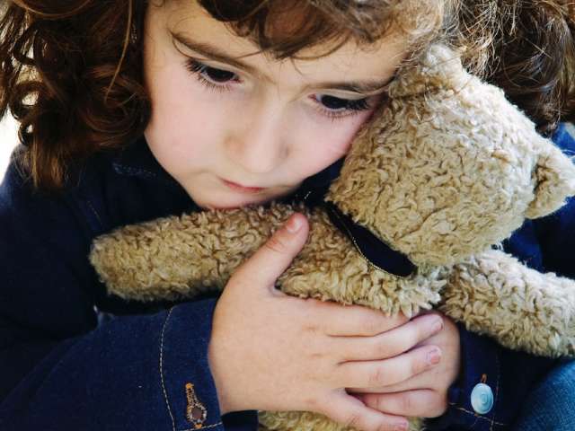 Image of young girl holding a teddy bear.