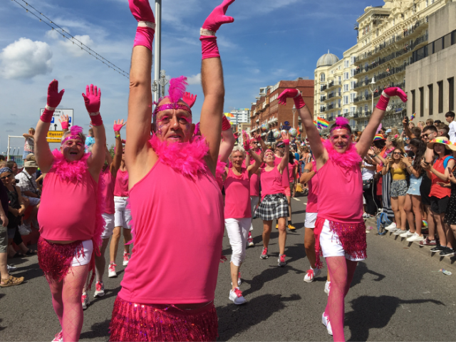Photo of a group of people dressed as flamingos.