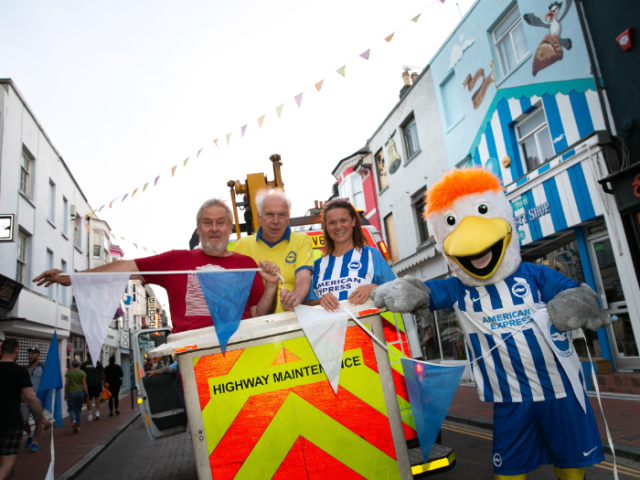 Council leader Bella Sankey, Cllr Ty Goddard and Lord Bassam put up bunting with help from Albion mascot Gully.