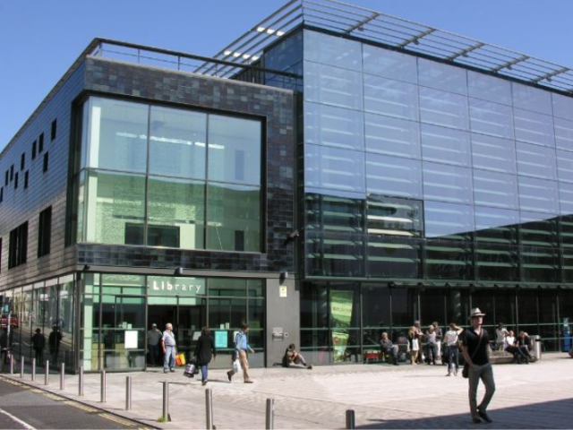 Photograph of a glass fronted modern library.