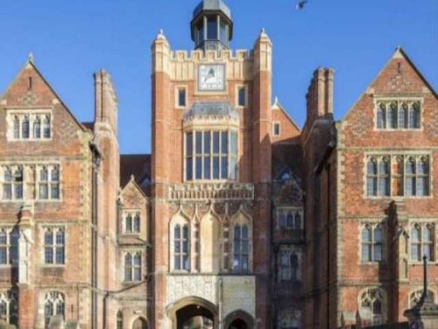 The clock tower of Brighton College pictured on a sunny day against a clear blue sky