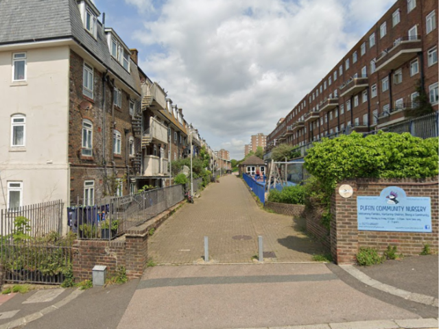 Photo looking along Nelson Row, between the Kingswood and Milner blocks of flats. Photo credit: Google.