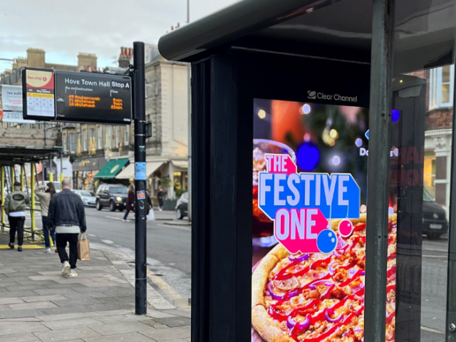 Bus shelter with a pizza ad being displayed