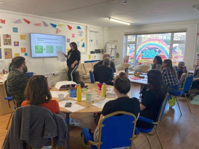 A group of young people sitting at desks listening to a presentation at a workshop in Brighton & Hove's Youth Employment Hub