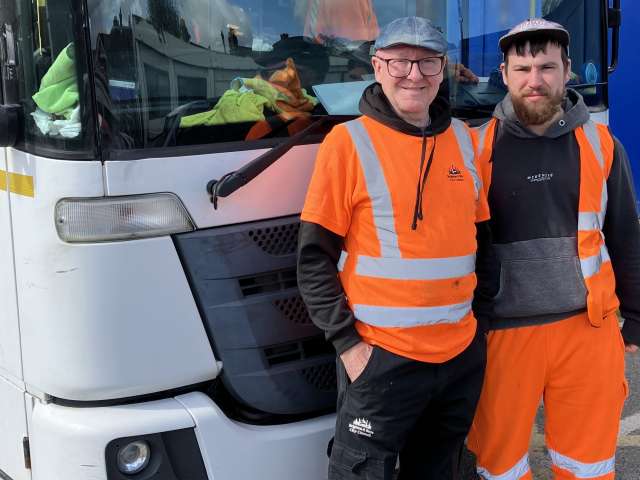 Image shows Cityclean crew Billy Lee and Ryan Bones standing in front of a Cityclean lorry