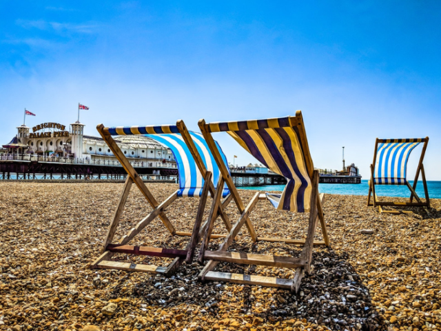Two deck chairs on a beach