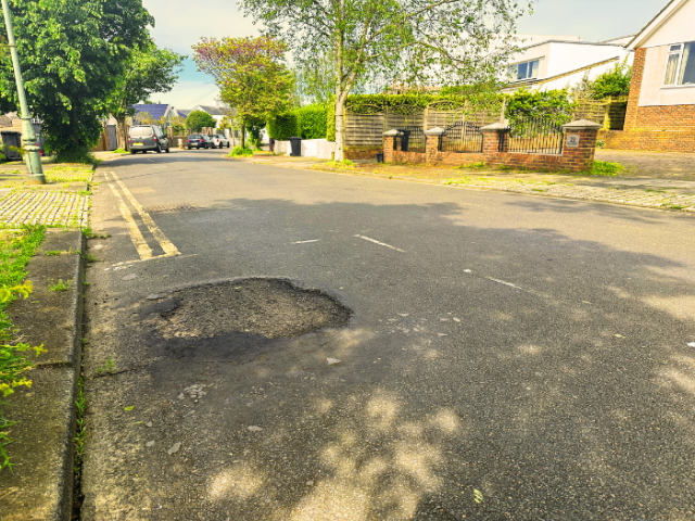 A pothole on a road.