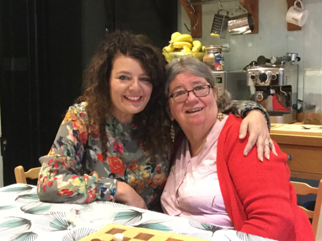 Two people sitting at a kitchen table
