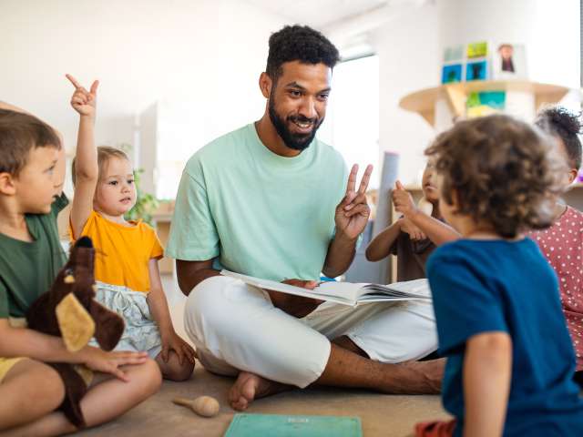 Adult teaching children in a classroom
