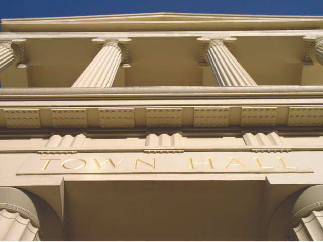 Front of the town hall, showing pillars and sign