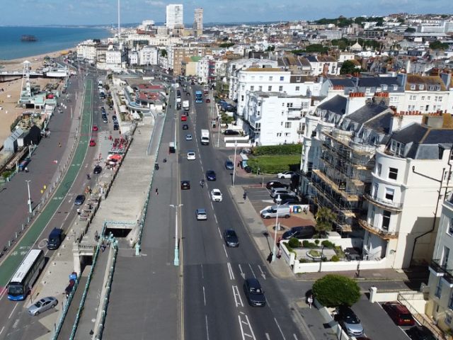 a picture from above of a road with pavements and houses either side