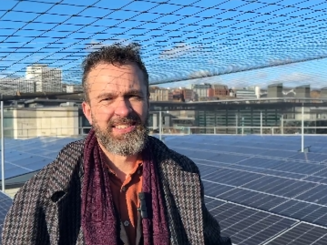 Councillor Tim Rowkins with the solar panels on the roof of the Prince Regent Swimming complex