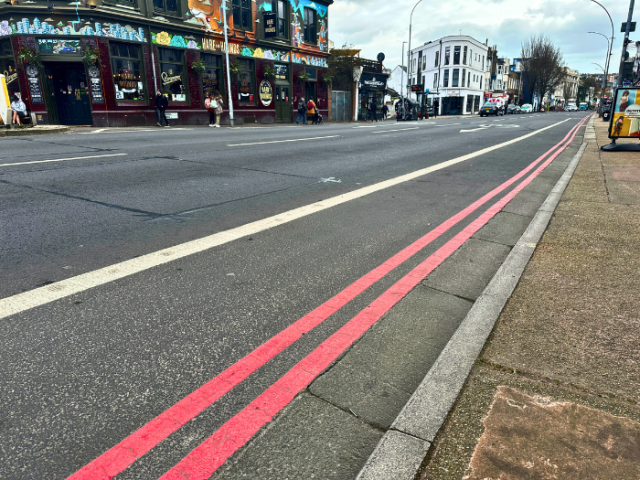 A picture of a road with double red lines