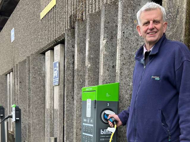 Councillor Trevor Muten with the electric vehicle (EV) charging points outside Hove Town Hall